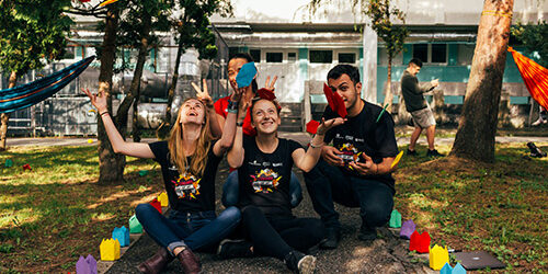 Volunteers sitting on the ground celebrating