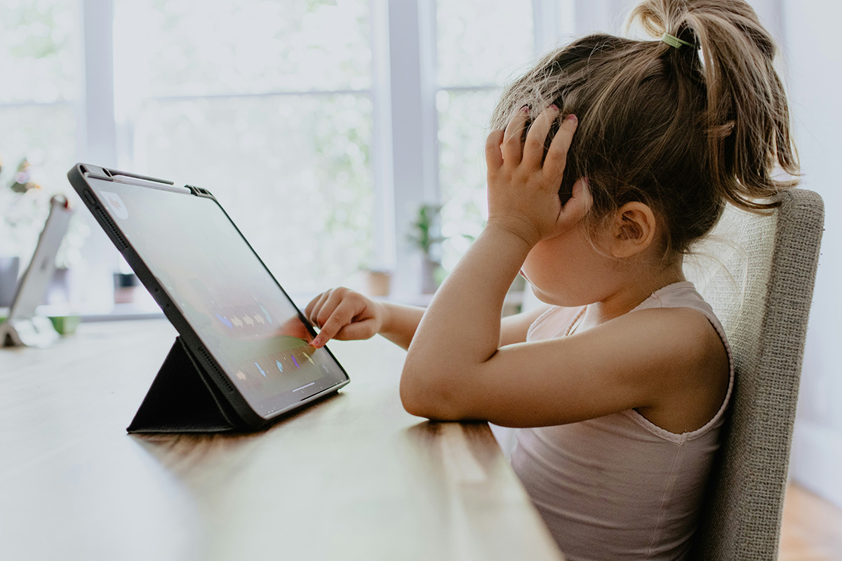 young girl looking at an iPad screen