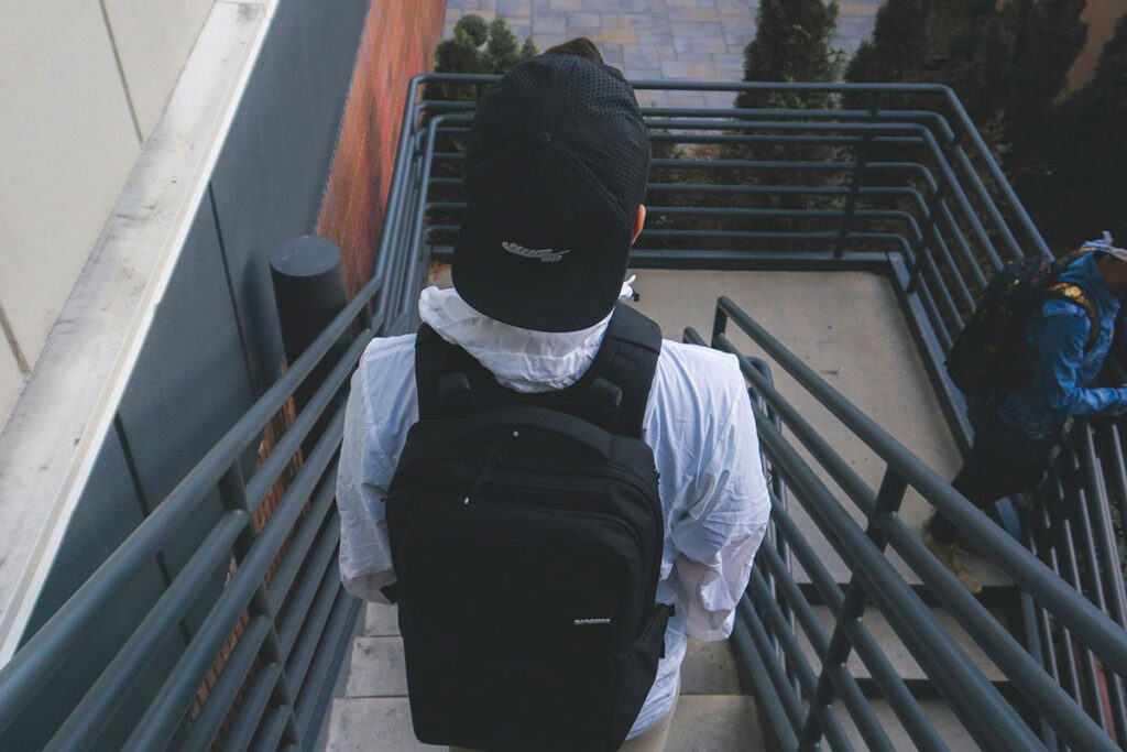 a kid standing on the top of a staircase at school