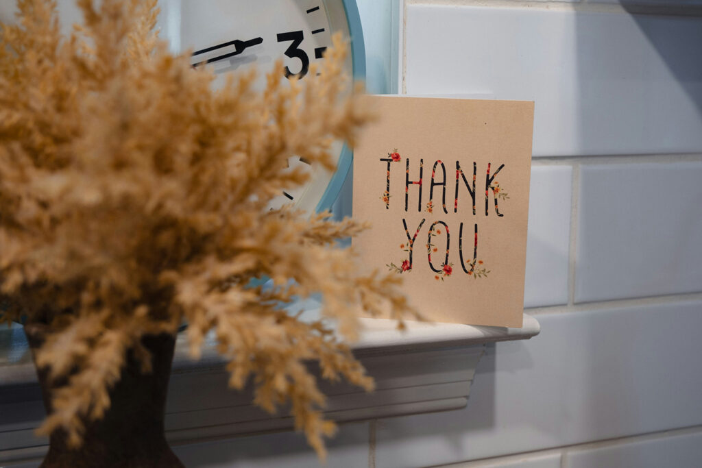 card sitting on a mantle that says thank you